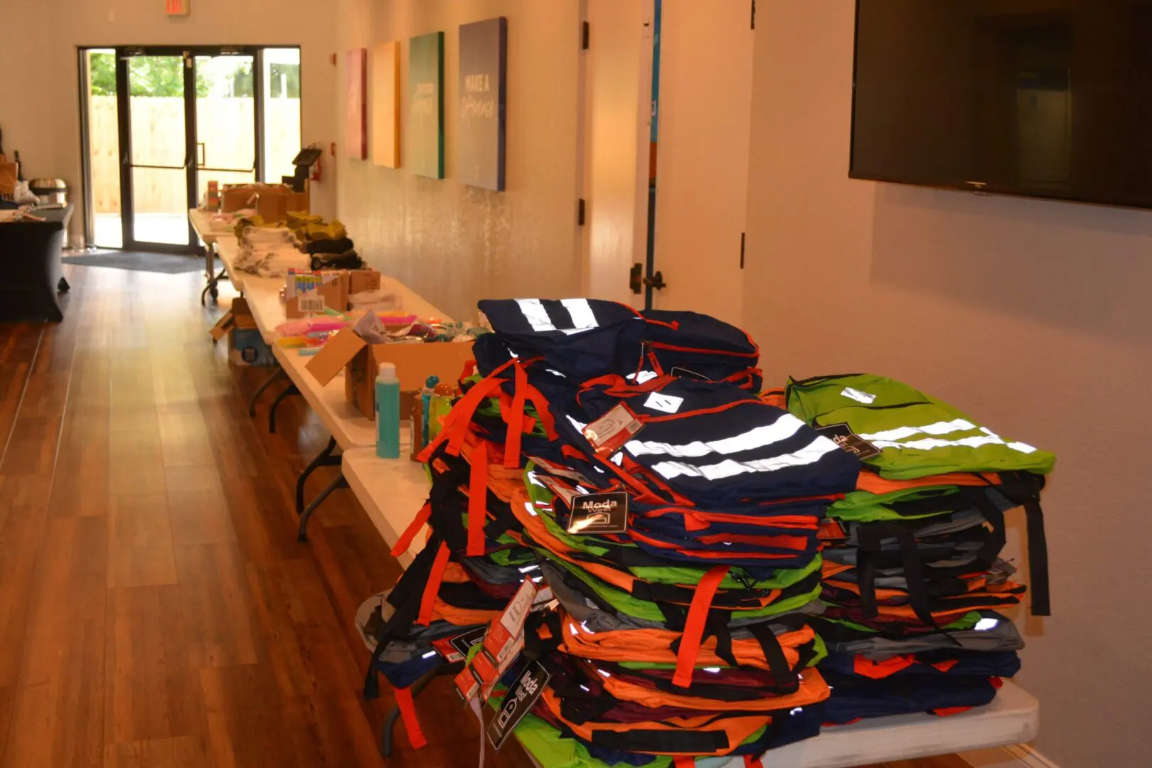 A table with many bags of clothes on it