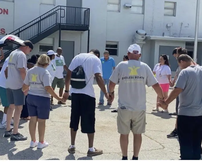A group of people standing around each other.