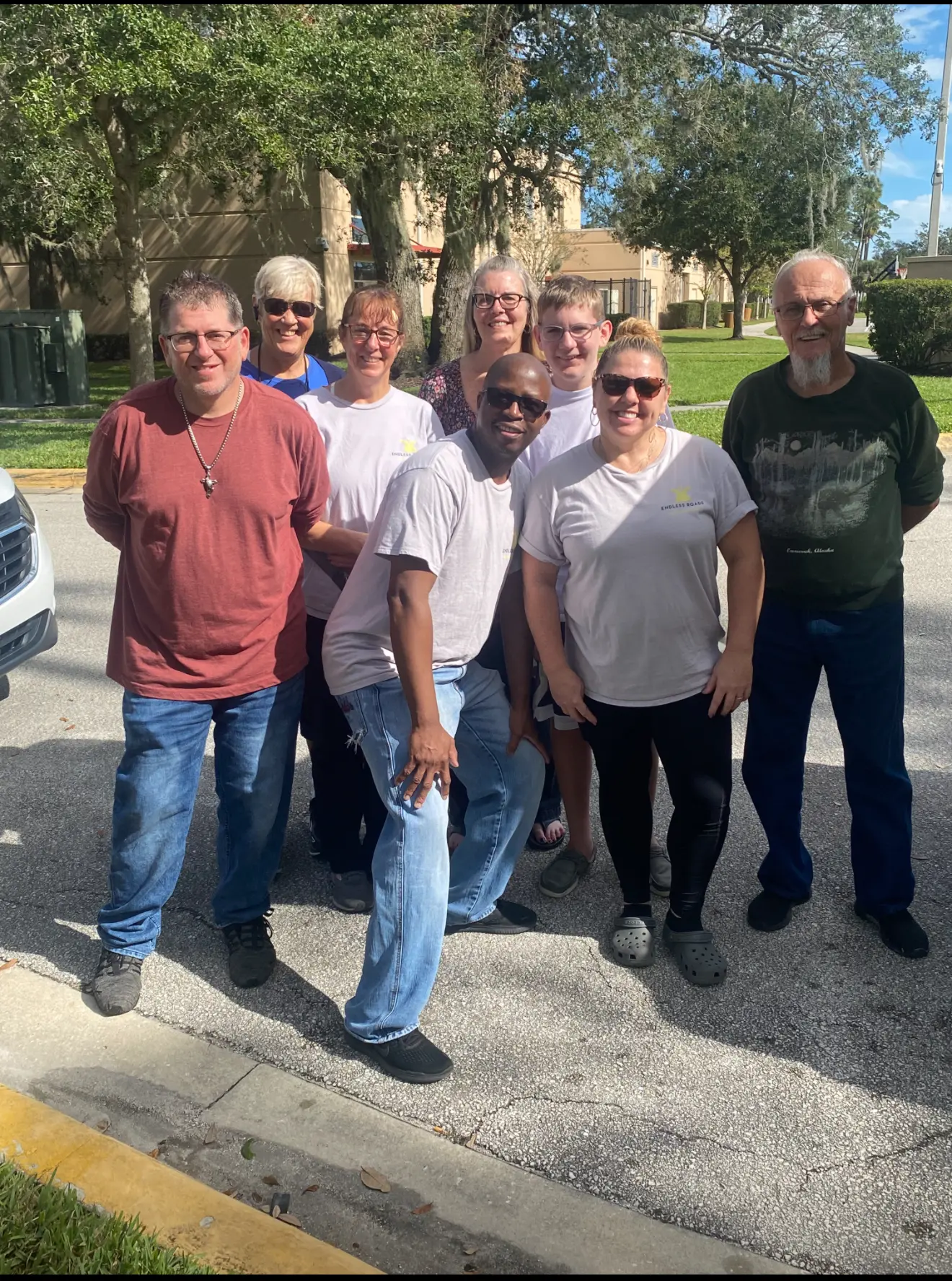 A group of people standing on the side walk