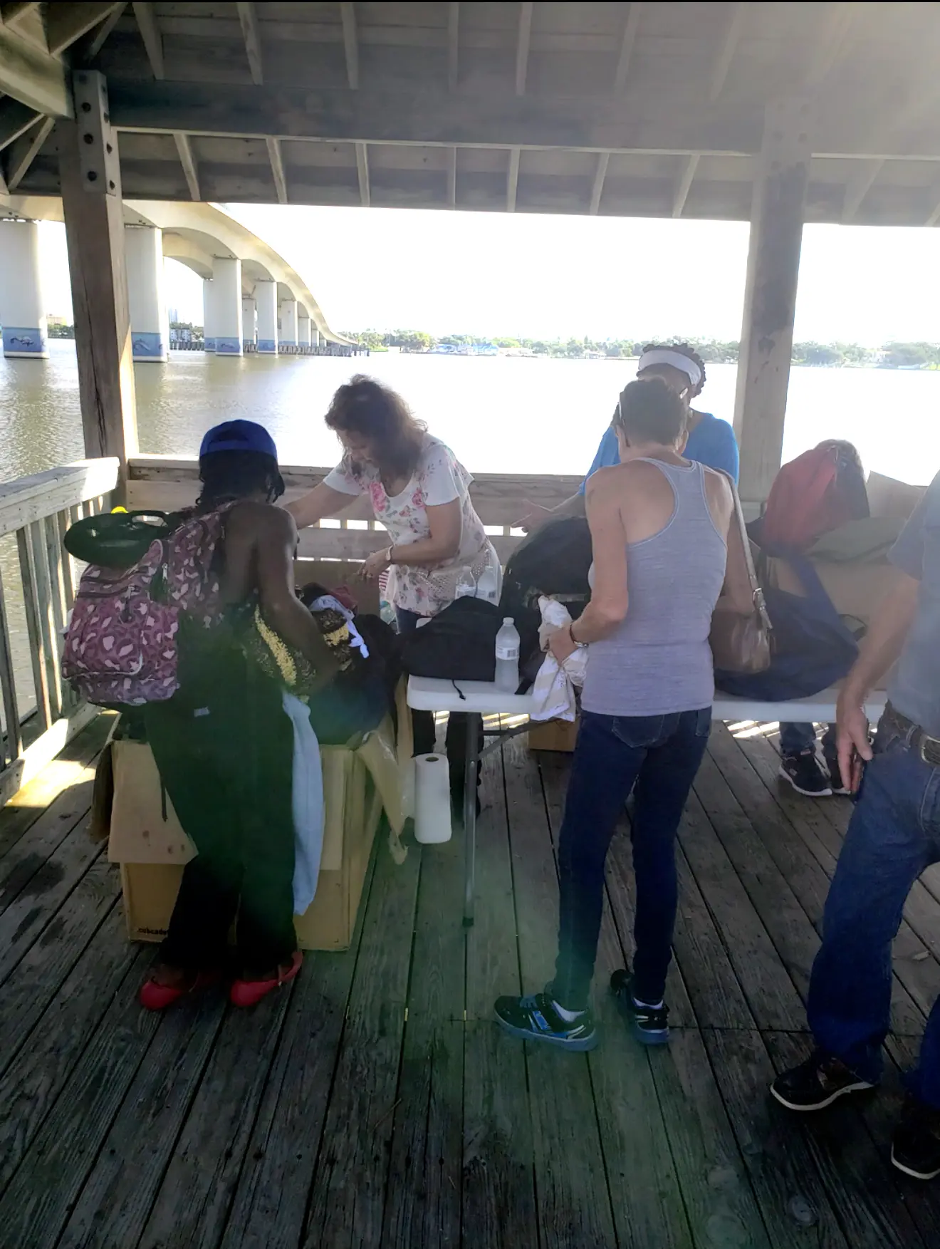 A group of people standing around a table.