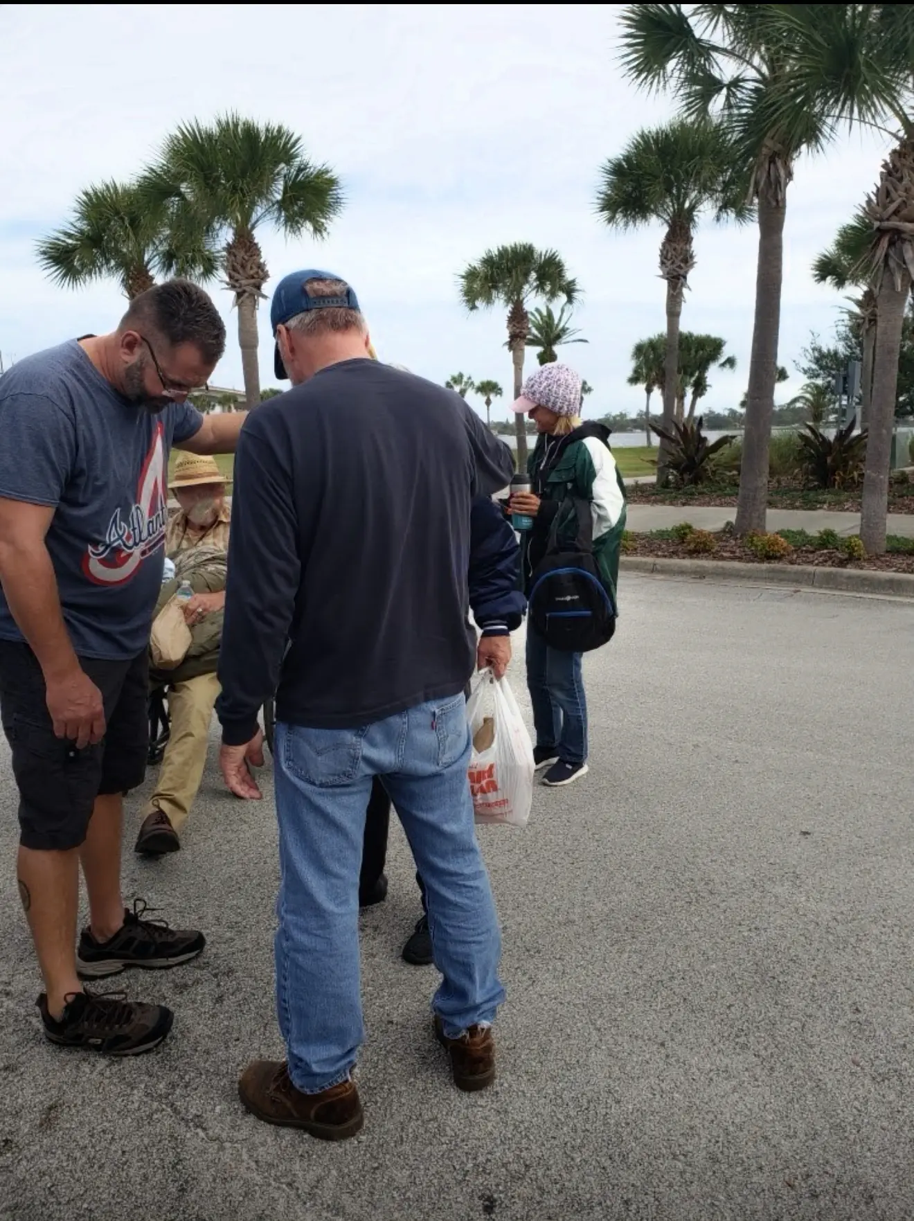 A group of men standing on the side walk