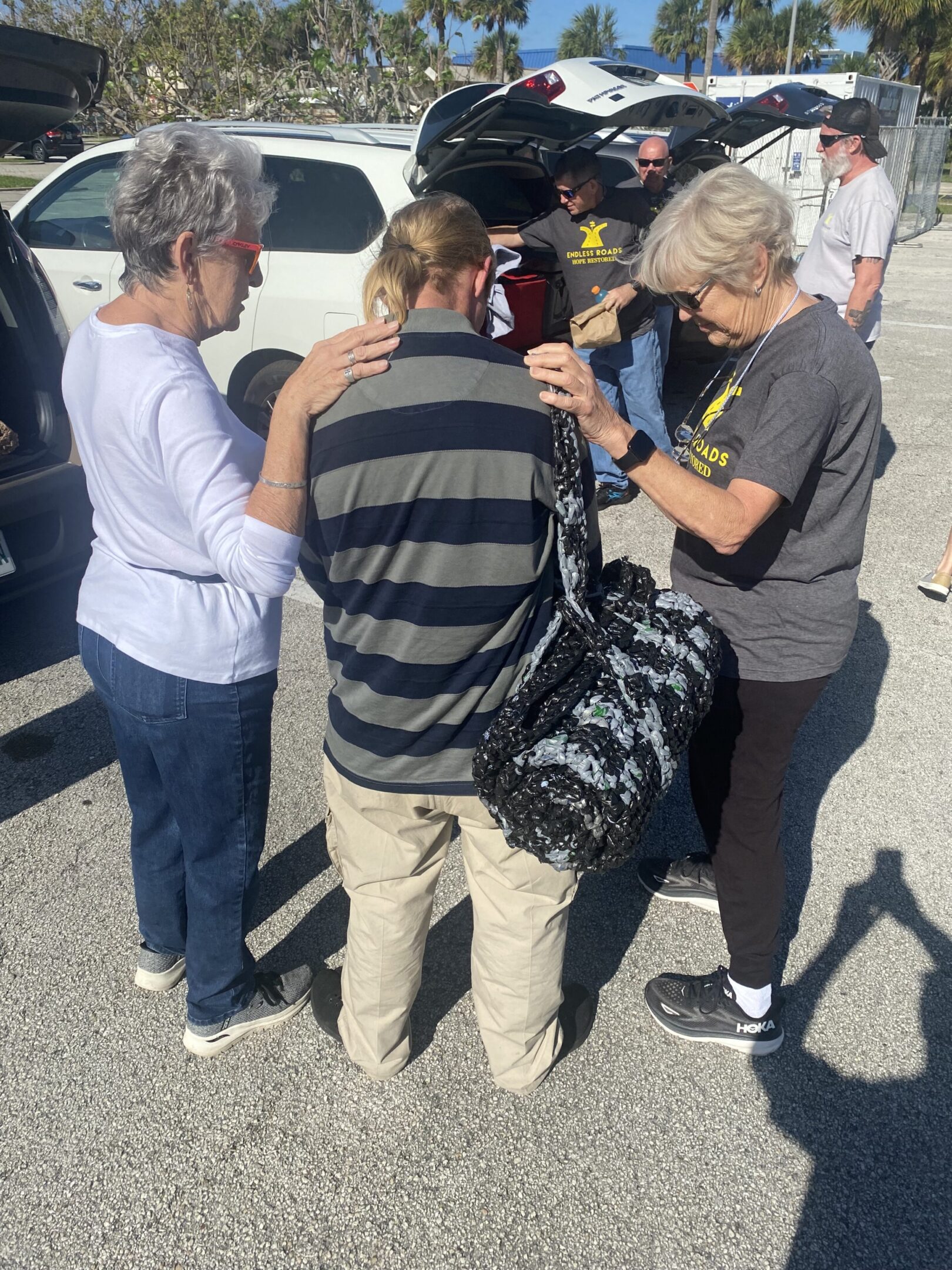 A group of people standing around each other.