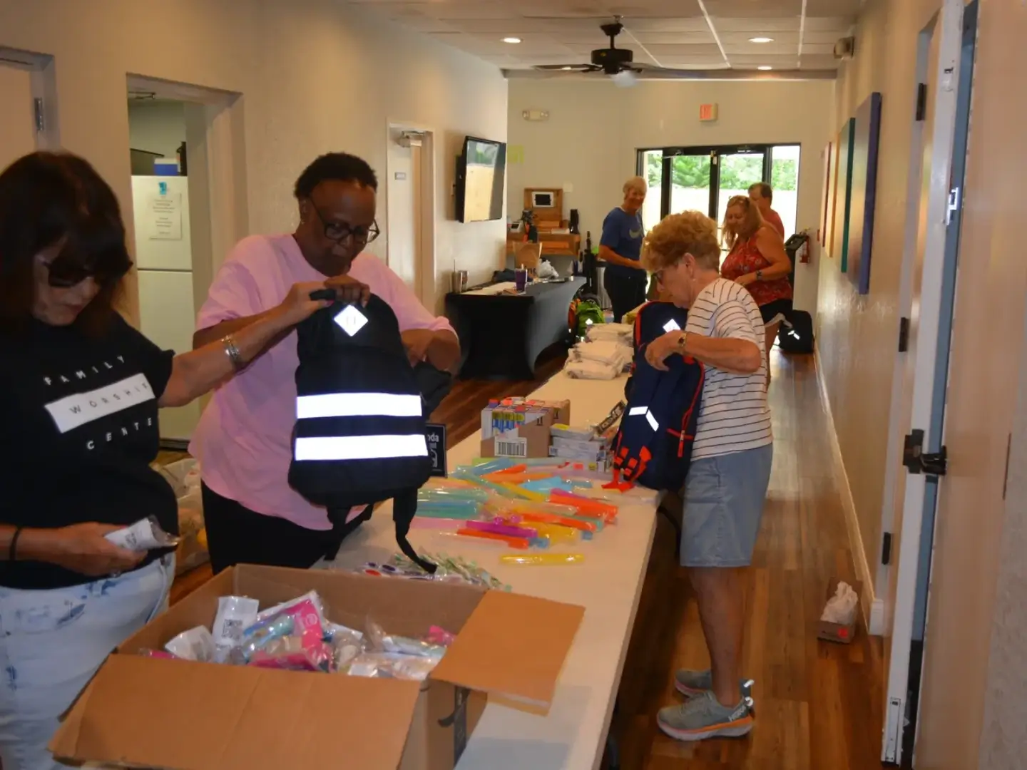 A man and woman are preparing to put on their jackets.